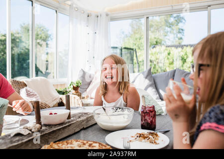 Happy girl at table Stock Photo