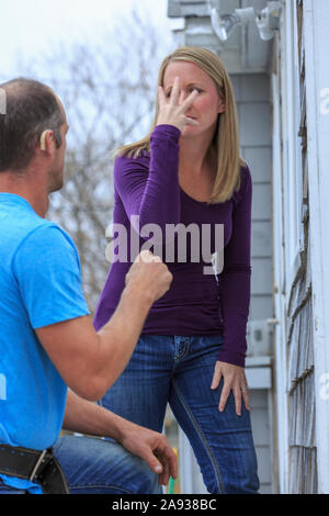 Homeowner communicating with home repairman in American Sign Language, saying 'Beautiful' and 'Yes' Stock Photo