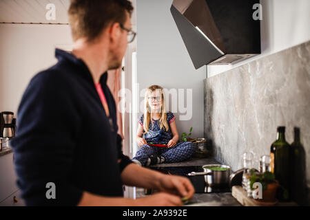 Father and daughter in kitchen Stock Photo