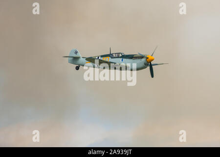Hispano HA-1112-M4L two seat dual control Buchon Me109, flying through smoke. England, UK Stock Photo
