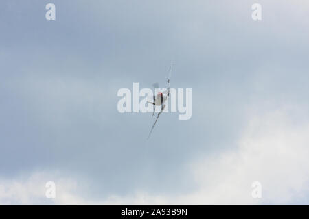 Front view of a BBMF Spitfire MK9 emerging from clouds. England UK Stock Photo