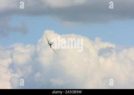 Front view of a Supermarine Spitfire emerging from the clouds. England UK Stock Photo
