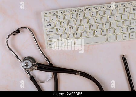 Stethoscope and keyboard computer on modern medical information technology and gadget diagnostics flat lay top view Stock Photo