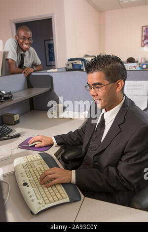 Two men with Autism working on computer in an office Stock Photo