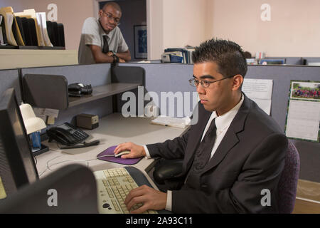 Two men with Autism working on computer in an office Stock Photo