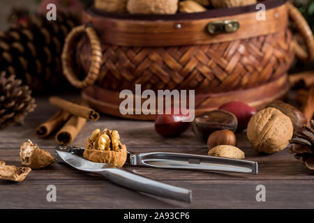 Close up mixed nuts in shells and cracker. Stock Photo