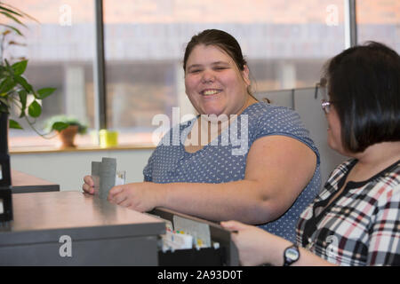 Two women with Learning Disabilities working in an office Stock Photo