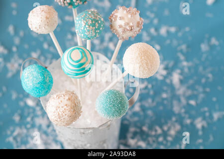 Bouquet of decorated cake pops on blue. Stock Photo