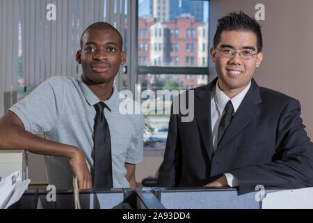 Portrait of two men with Autism smiling in an office Stock Photo