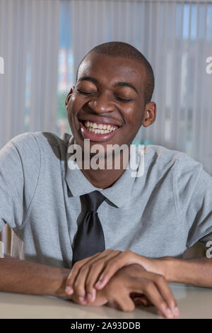 Happy African American man with Autism working in an office Stock Photo