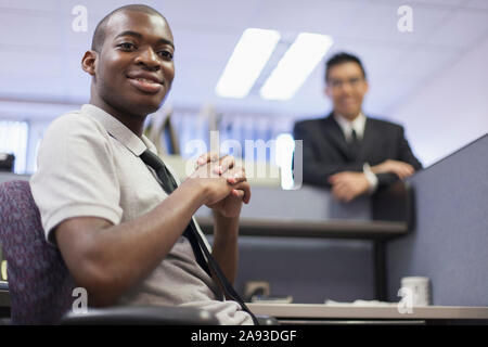Happy portrait of two men with Autism working in an office Stock Photo