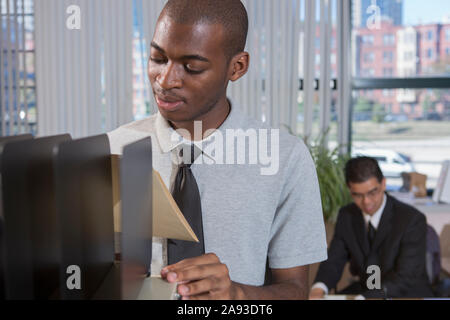 Two men with Autism working in an office Stock Photo