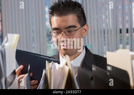 Asian man with Autism working in an office Stock Photo