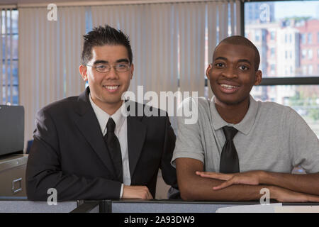 Portrait of two men with Autism smiling in an office Stock Photo