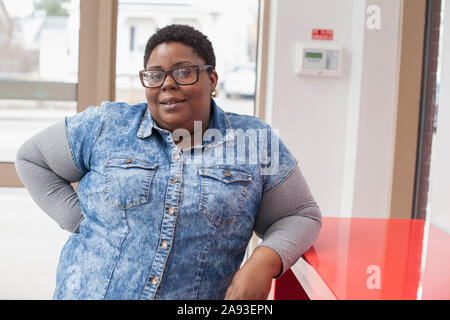 Portrait of a happy woman with bipolar disorder at her bank Stock Photo