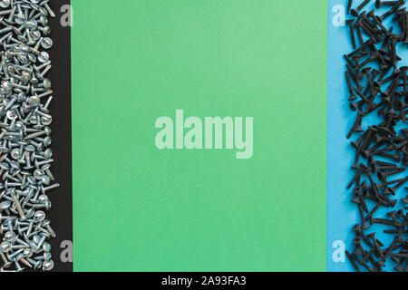 Flat Lay Composition With Different Screws on Black, Green and Blue Background. Top View of Checklist Concept Stock Photo