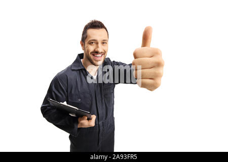 Cheerful male worker with a clipboard showing thumbs up isolated on white background Stock Photo