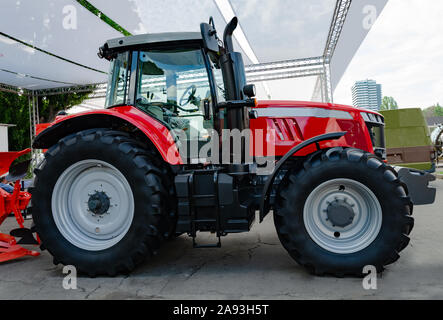 Red large tractor, machine for sowing, preparation and cultivation of soil for farmers Stock Photo