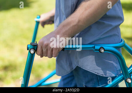 Young man with Cerebral Palsy using his walker Stock Photo