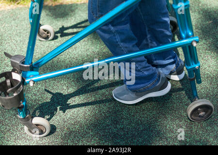 Young man with Cerebral Palsy using his walker Stock Photo