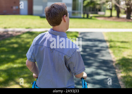 Young man with Cerebral Palsy using his walker to walk to work Stock Photo