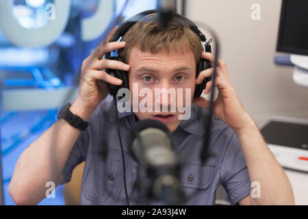 Young man with Cerebral Palsy hosting his radio show Stock Photo