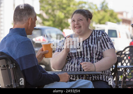 Woman with Visual Impairment sitting at a cafÃ© with her father Stock Photo