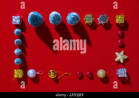 Frame made from Christmas decorations on a red background Stock Photo