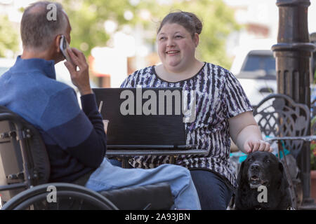 Woman with Visual Impairment sitting at a cafÃ© with her father Stock Photo