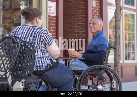 Woman with Visual Impairment sitting at a cafÃ© with her father Stock Photo