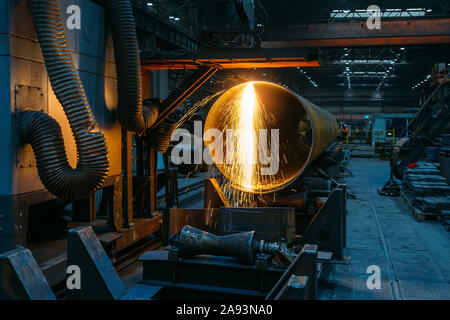 Plasma cutting machine with CNC cutting steel pipe with sparks. Stock Photo