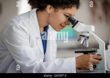 Scientist using a microscope Stock Photo