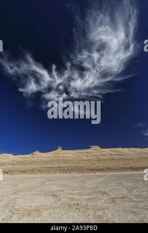 Cirrus uncinus cloud over wind-eroded horse head-shaped yardangs. Qaidam desert-Qinghai-China-0585 Stock Photo