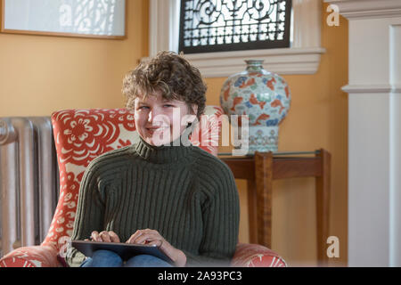 Woman with Sjogren-Larsson Syndrome using a digital tablet Stock Photo