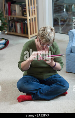 Woman with Autism using a digital tablet Stock Photo