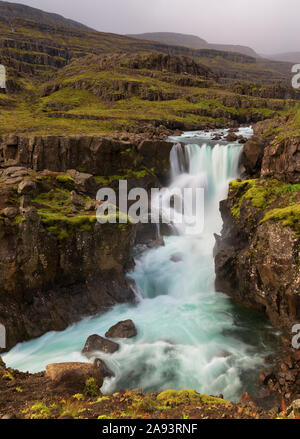 Sveinsstekksfoss waterfall of Fossa river on Berufjordur fjord in easterrn Iceland Stock Photo