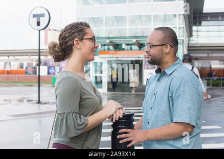 African American man who has Down Syndrome talking with a friend Stock Photo
