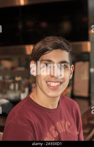 Young man with Fragile X Syndrome working in a restaurant Stock Photo