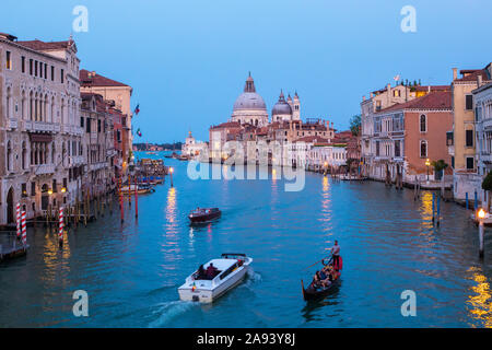 Venice, UK - July 19th 2019: The view from Ponte dell'Accademia taking in the sights of the Grand Canal and Basilica di Santa Maria della Salute in th Stock Photo