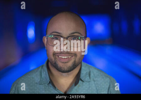 Man with Down Syndrome in bowling alley Stock Photo