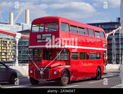 A vintage iconic red double decker bus in chelsea bridge london advertised for events use Stock Photo