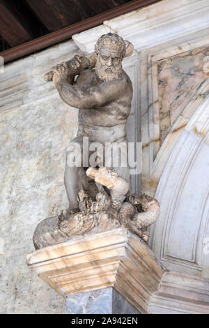 Venice, Italy - July 18th 2019: A sculpture of Hercules, located at the bottom of the Golden Staircase, at the Doges Palace, or Palazzo Ducale in the Stock Photo