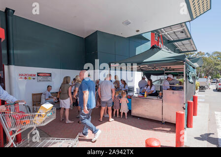 A fund raising sausage sizzle BBQ for the Life Line charity facilitated by and operating at the entrance to a Bunnings Warehouse DIY store in Sydney. Stock Photo
