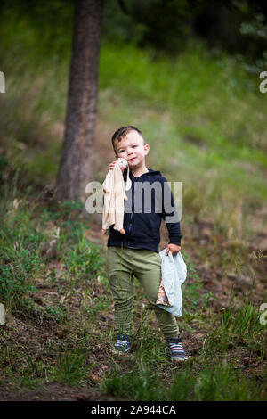 Portrait of toddler boy holding bunny and his small blanket. Stock Photo