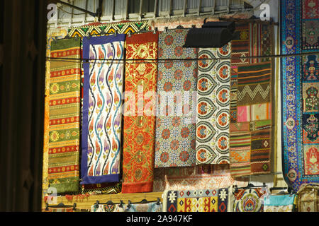 Handmade carpets displayed on a street stall at grand bazar. Stock Photo