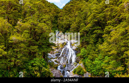 Water flows over rocks on Fantail Falls; South Island, New Zealand Stock Photo