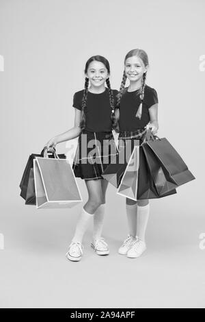 Shopping happiness. black friday. holiday presents. Sale and discount. girls shopping. happy children with shopping bags. successful shopping. big sales. school girls with packages. purchase. Stock Photo