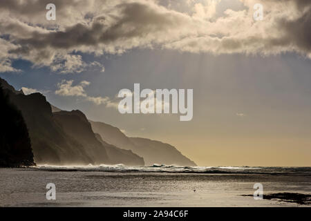 Sunlight on the Na Pali coast at Ke'e Beach; Kauai, Hawaii, United States of America Stock Photo