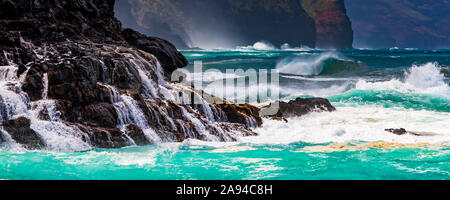 Waves of the turquoise Pacific Ocean water on the North shore of the Na Pali Coast; Kauai, Hawaii, United States of America Stock Photo