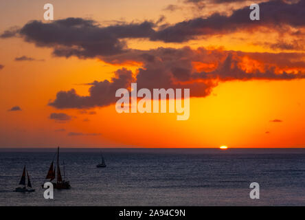 Sailing off Waikiki Beach at sunset; Honolulu, Oahu, Hawaii, United States of America Stock Photo